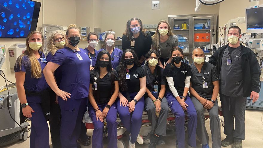 Group of emergency room nurses and technicians posing for a photo