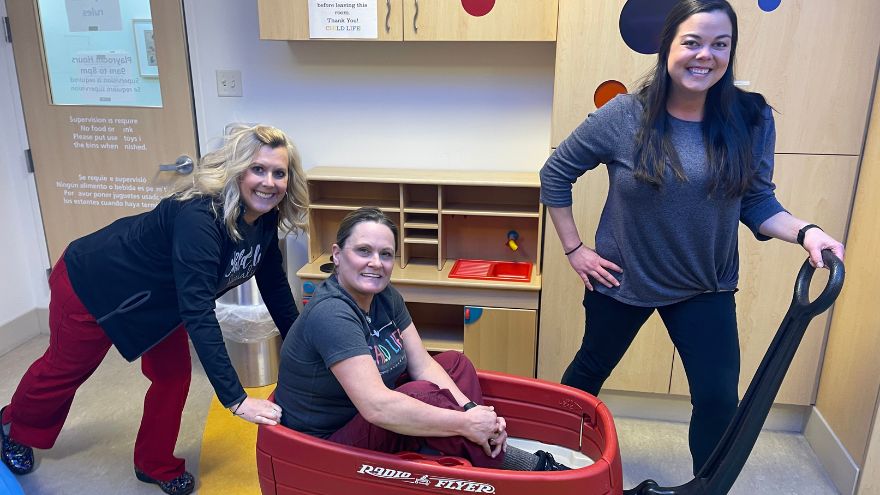 The Child Life department at Renown Health pose for a photo in the kids' playroom.