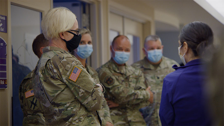 Members of National Guard stand with Renown Health employee