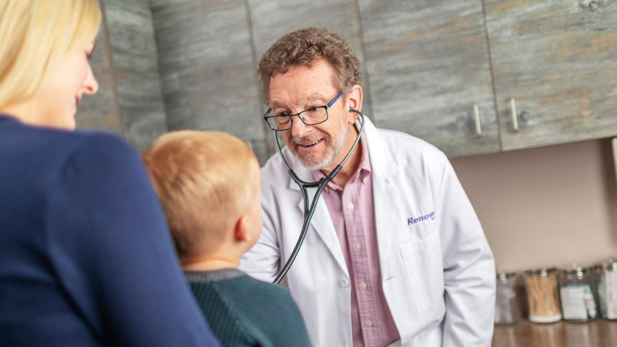 A doctor examining a child 