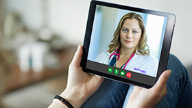 Renown Medical Group provider in Carson City conducting a virtual visit with patient on tablet device