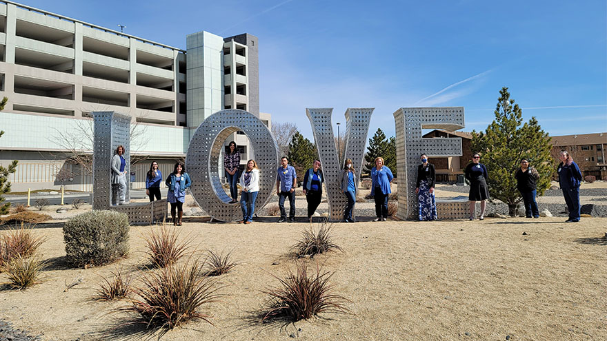 renown staff standing in front of the Love sign